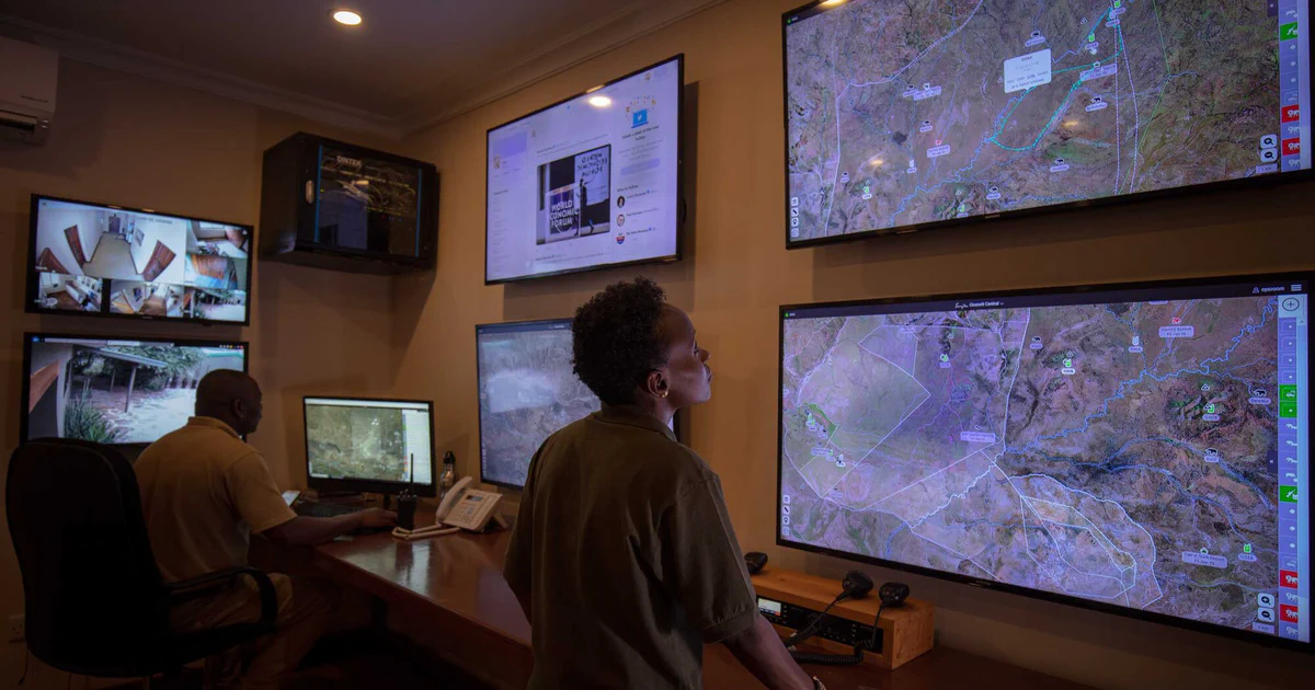 An EarthRanger operations room with live maps on wall screens